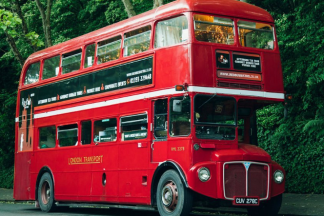 a double decker bus driving down a street